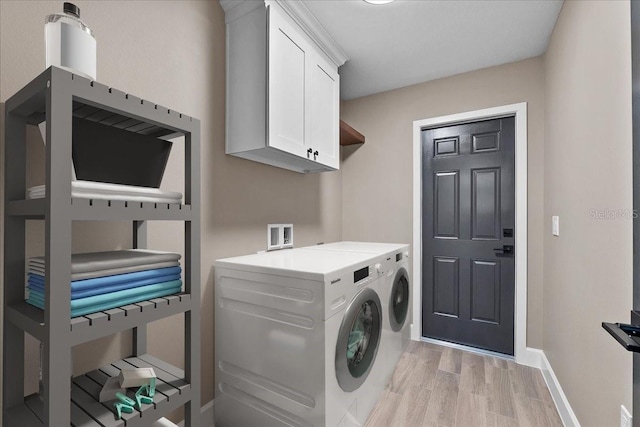3063 Lantana Cir, Auburndale, FL 33823 - laundry area featuring cabinet space, washer and clothes dryer, and light wood-style flooring
