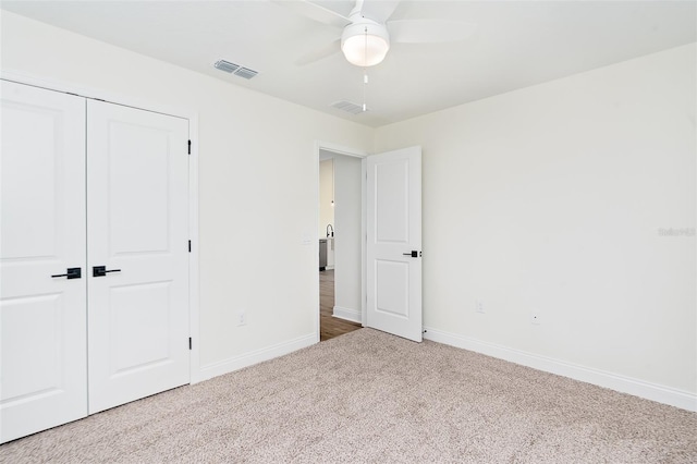 724 Voight Ave N, Fort Meade, FL 33841 - unfurnished bedroom featuring carpet, a closet, and ceiling fan