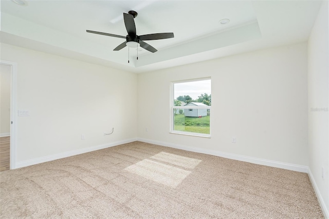 724 Voight Ave N, Fort Meade, FL 33841 - empty room featuring carpet, a raised ceiling, and ceiling fan