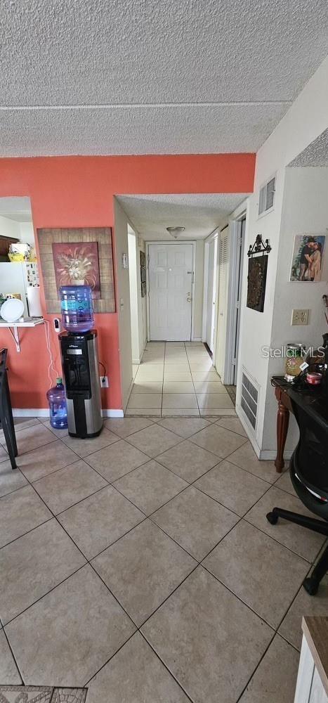 5627 Blue Shadows Ct Unit 3, Orlando, FL 32811 - hallway with a textured ceiling and tile patterned floors
