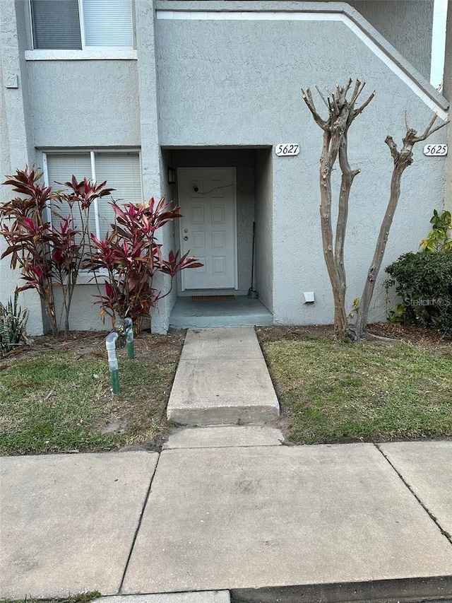 5627 Blue Shadows Ct Unit 3, Orlando, FL 32811 - doorway to property with stucco siding