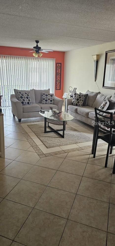 5627 Blue Shadows Ct Unit 3, Orlando, FL 32811 - tiled living area with a ceiling fan and a textured ceiling