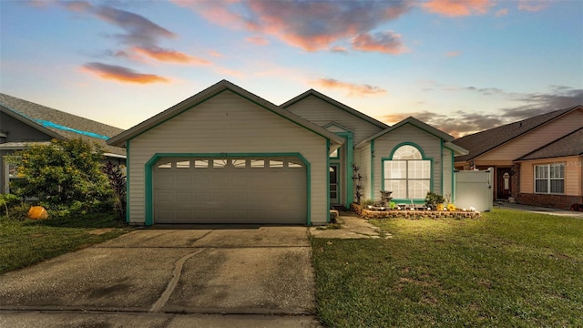 526 Allison Ave, Davenport, FL 33897 - view of front of property with a garage, driveway, and a front lawn