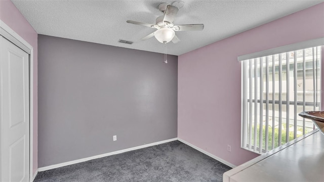 526 Allison Ave, Davenport, FL 33897 - empty room featuring healthy amount of natural light, ceiling fan, a textured ceiling, and carpet flooring
