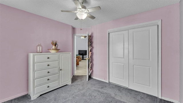 526 Allison Ave, Davenport, FL 33897 - bedroom with light carpet, a textured ceiling, a closet, and ceiling fan