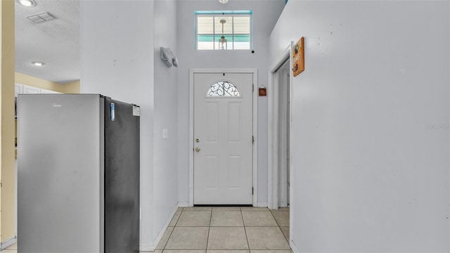 526 Allison Ave, Davenport, FL 33897 - doorway to outside with light tile patterned flooring and a textured ceiling