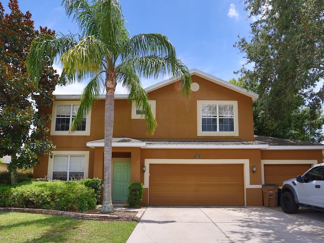 1911 Wind Meadows Dr, Bartow, FL 33830 - view of front facade featuring driveway, an attached garage, and stucco siding