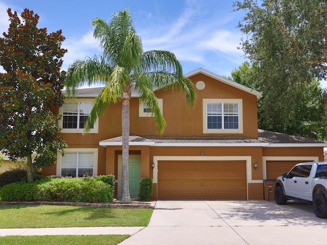 1911 Wind Meadows Dr, Bartow, FL 33830 - view of front of house with a garage, driveway, and stucco siding