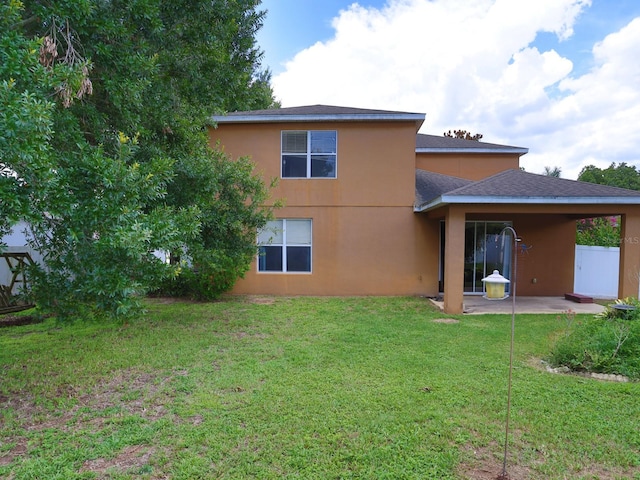 1911 Wind Meadows Dr, Bartow, FL 33830 - back of house with a patio, a yard, stucco siding, and roof with shingles