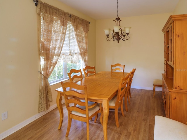 1911 Wind Meadows Dr, Bartow, FL 33830 - dining room featuring a chandelier and light wood-style flooring