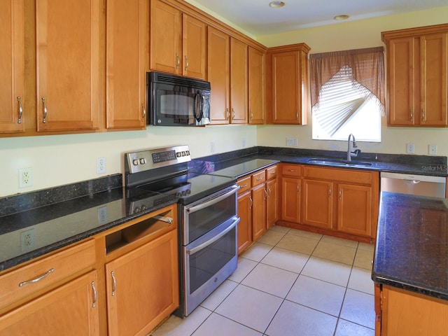 1911 Wind Meadows Dr, Bartow, FL 33830 - kitchen with appliances with stainless steel finishes, dark stone counters, and brown cabinetry
