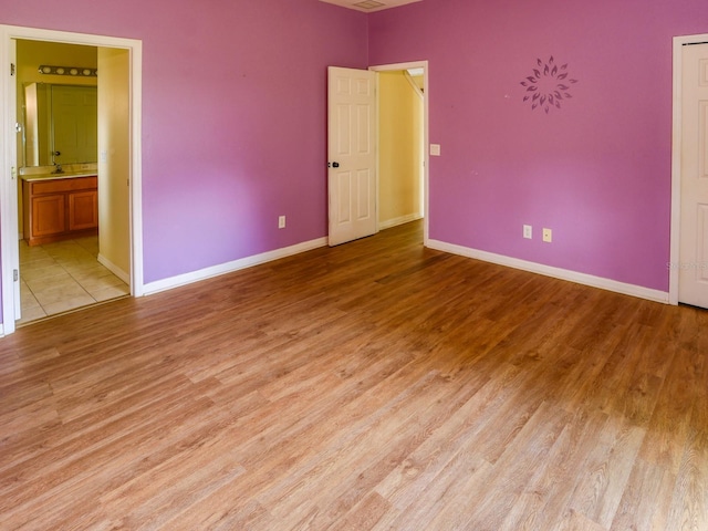 1911 Wind Meadows Dr, Bartow, FL 33830 - unfurnished bedroom with light wood-style flooring and ensuite bathroom