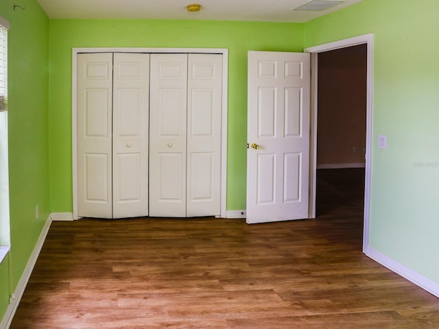 1911 Wind Meadows Dr, Bartow, FL 33830 - unfurnished bedroom with a closet and wood finished floors