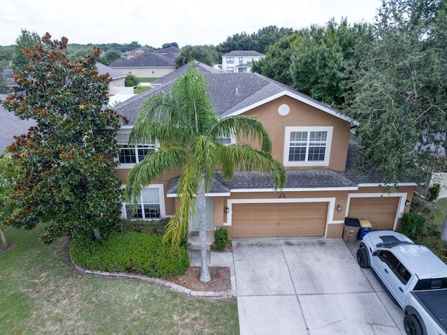 1911 Wind Meadows Dr, Bartow, FL 33830 - view of front facade featuring stucco siding, a shingled roof, an attached garage, and concrete driveway
