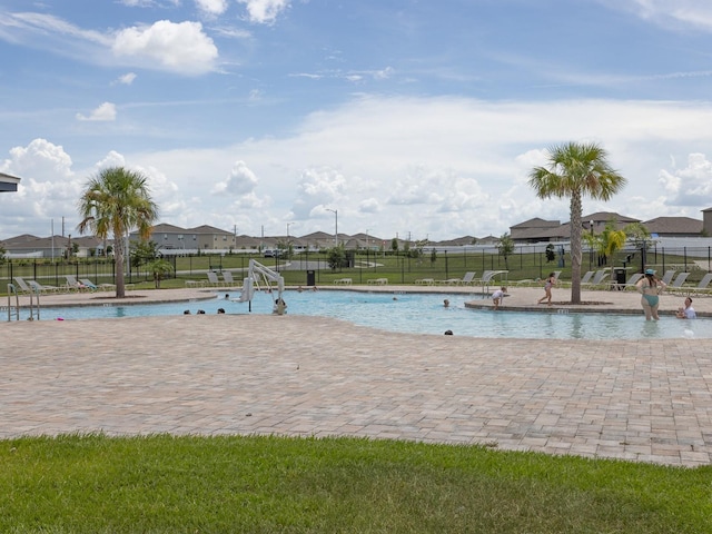 1911 Wind Meadows Dr, Bartow, FL 33830 - community pool featuring a residential view and a patio