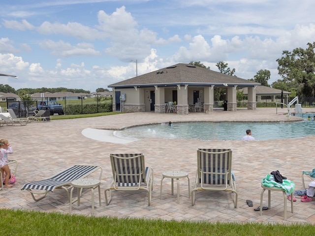 1911 Wind Meadows Dr, Bartow, FL 33830 - community pool featuring a patio area