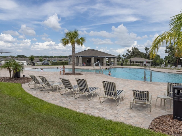 1911 Wind Meadows Dr, Bartow, FL 33830 - community pool featuring a patio area