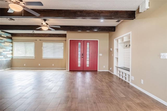 252 W Brookins Ave, Eagle Lake, FL 33839 - foyer featuring a textured ceiling, a ceiling fan, wood finished floors, beamed ceiling, and plenty of natural light