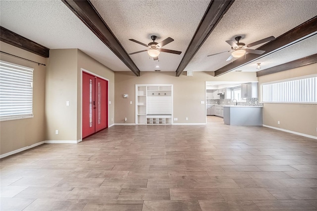 252 W Brookins Ave, Eagle Lake, FL 33839 - unfurnished living room featuring ceiling fan, beamed ceiling, and a textured ceiling
