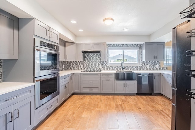 252 W Brookins Ave, Eagle Lake, FL 33839 - kitchen featuring stainless steel appliances, gray cabinetry, light countertops, decorative backsplash, and recessed lighting