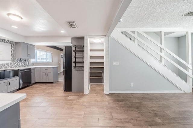 252 W Brookins Ave, Eagle Lake, FL 33839 - kitchen featuring stainless steel appliances, gray cabinetry, light countertops, light wood-style floors, and recessed lighting