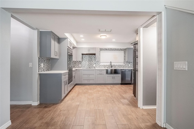 252 W Brookins Ave, Eagle Lake, FL 33839 - kitchen featuring gray cabinets, appliances with stainless steel finishes, light wood finished floors, backsplash, and recessed lighting