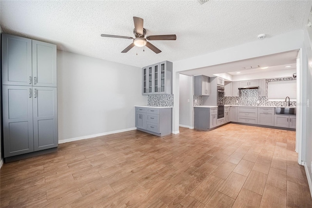 252 W Brookins Ave, Eagle Lake, FL 33839 - unfurnished living room featuring a ceiling fan, light wood-style flooring, and a textured ceiling