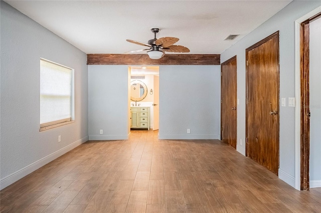 252 W Brookins Ave, Eagle Lake, FL 33839 - unfurnished bedroom with two closets, wood finished floors, ceiling fan, and ensuite bath
