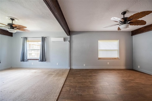 252 W Brookins Ave, Eagle Lake, FL 33839 - empty room with ceiling fan, a wall mounted AC, a textured ceiling, wood finished floors, and beamed ceiling