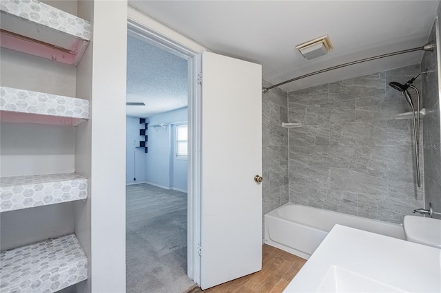 252 W Brookins Ave, Eagle Lake, FL 33839 - bathroom featuring bathing tub / shower combination and wood finished floors