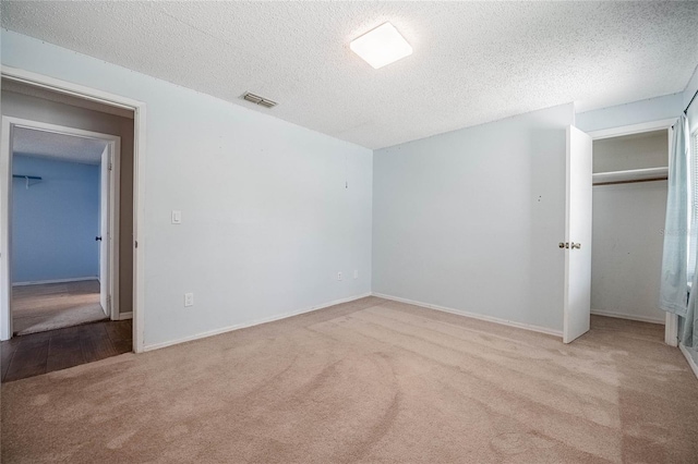 252 W Brookins Ave, Eagle Lake, FL 33839 - unfurnished bedroom with carpet flooring, a textured ceiling, and a closet