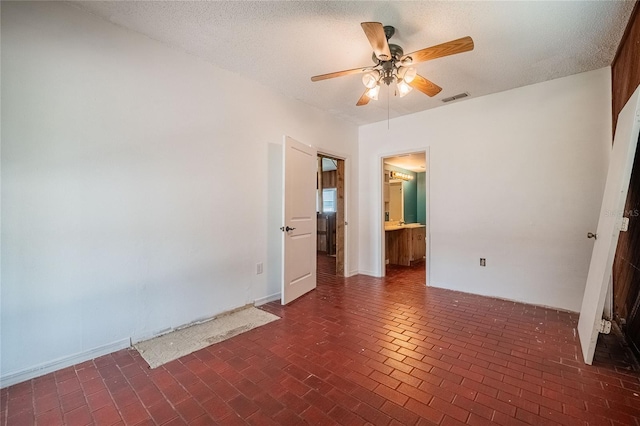 252 W Brookins Ave, Eagle Lake, FL 33839 - spare room with a ceiling fan, brick floors, and a textured ceiling