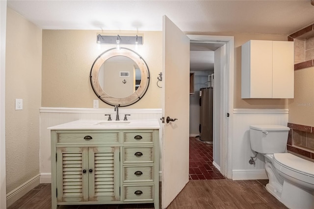 252 W Brookins Ave, Eagle Lake, FL 33839 - bathroom with electric water heater, vanity, and wood finished floors