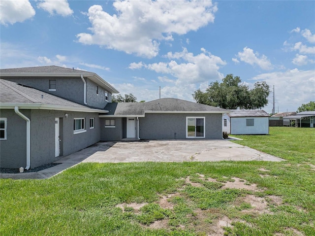 252 W Brookins Ave, Eagle Lake, FL 33839 - back of house with a patio, a lawn, and stucco siding