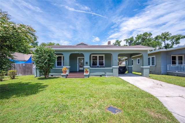 1515 King Ave, Lakeland, FL 33803 - ranch-style house with concrete driveway, a porch, a carport, and a chimney