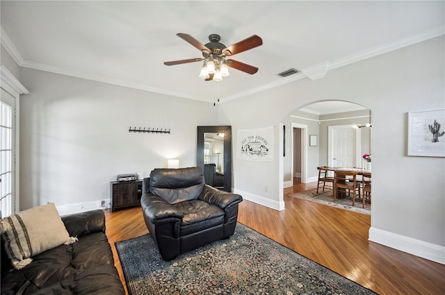 1515 King Ave, Lakeland, FL 33803 - living area with arched walkways, ornamental molding, ceiling fan, and wood finished floors