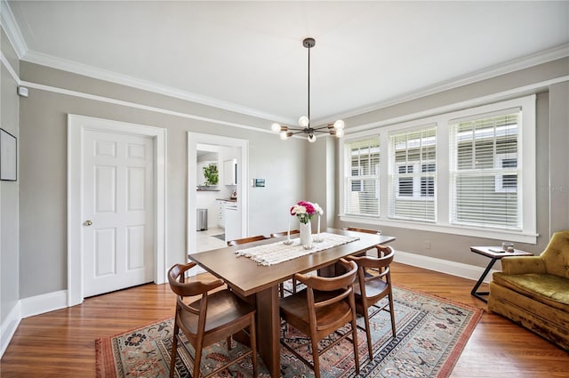 1515 King Ave, Lakeland, FL 33803 - dining space with crown molding, a chandelier, and wood finished floors