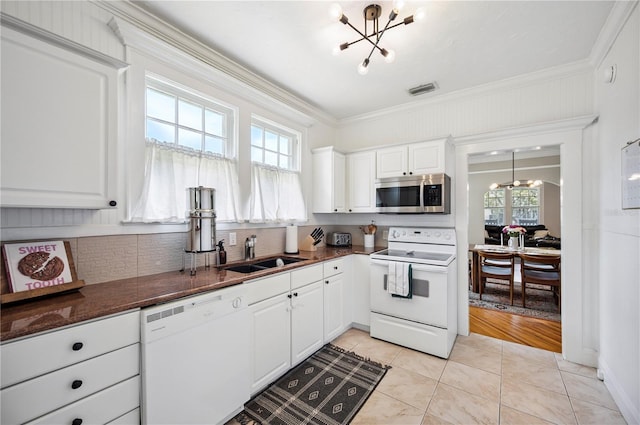 1515 King Ave, Lakeland, FL 33803 - kitchen with white appliances, a chandelier, healthy amount of natural light, and crown molding