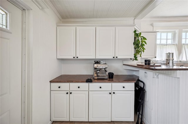 1515 King Ave, Lakeland, FL 33803 - kitchen featuring ornamental molding, dark countertops, white cabinets, and healthy amount of natural light