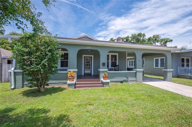 1515 King Ave, Lakeland, FL 33803 - view of front facade featuring covered porch, a chimney, and driveway