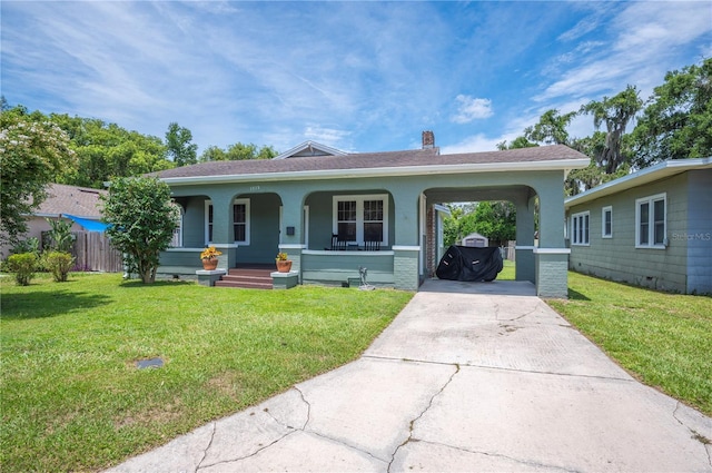 1515 King Ave, Lakeland, FL 33803 - ranch-style home with covered porch, driveway, and a front lawn
