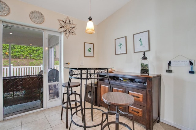 11607 Hammocks Glade Dr, Riverview, FL 33569 - dining room featuring tile patterned flooring, a dry bar, and lofted ceiling