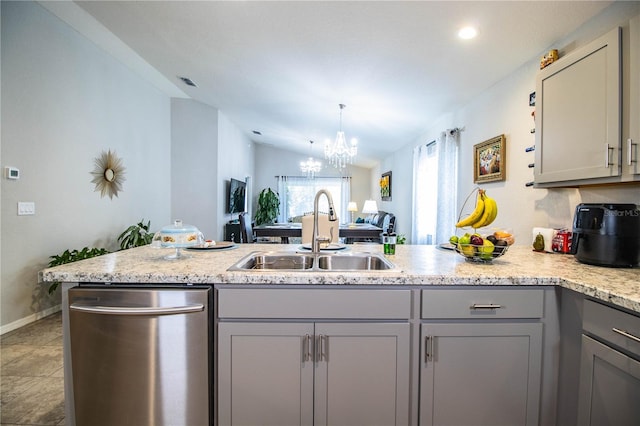 8031 Brookeshire Dr, Lakeland, FL 33809 - kitchen with gray cabinets, dishwasher, a peninsula, lofted ceiling, and a chandelier