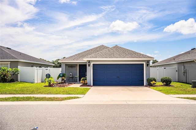 8031 Brookeshire Dr, Lakeland, FL 33809 - view of front facade with driveway, a garage, stucco siding, and a shingled roof
