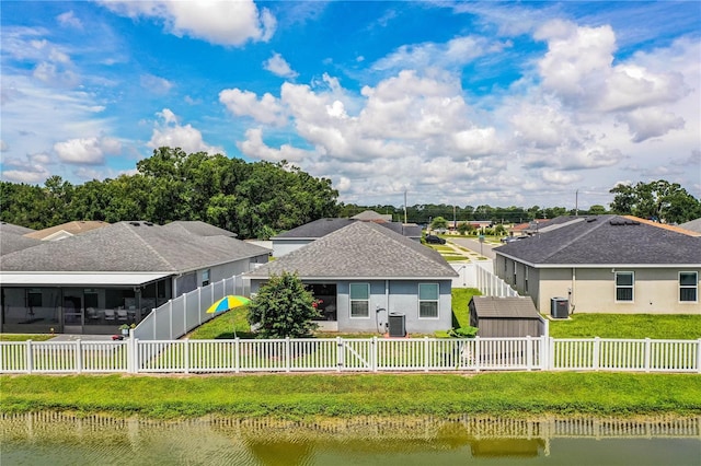 8031 Brookeshire Dr, Lakeland, FL 33809 - rear view of house with a fenced backyard, a water view, a storage shed, and a residential view