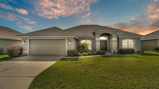 1156 Normandy Heights Cir, Winter Haven, FL 33880 - view of front of house with an attached garage, stucco siding, a front lawn, and driveway