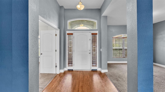 1156 Normandy Heights Cir, Winter Haven, FL 33880 - foyer entrance featuring a textured wall, wood finished floors, and a high ceiling