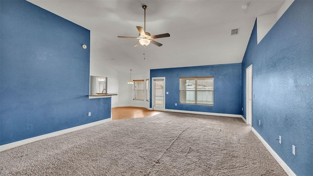 1156 Normandy Heights Cir, Winter Haven, FL 33880 - unfurnished living room featuring carpet floors, lofted ceiling, a ceiling fan, and a textured wall