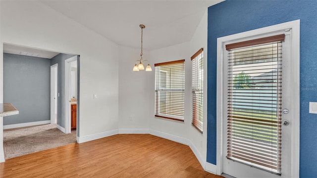 1156 Normandy Heights Cir, Winter Haven, FL 33880 - spare room with a chandelier and light wood-style flooring
