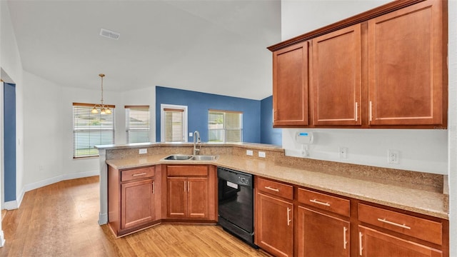 1156 Normandy Heights Cir, Winter Haven, FL 33880 - kitchen featuring black dishwasher, a peninsula, light wood-style floors, brown cabinetry, and decorative light fixtures